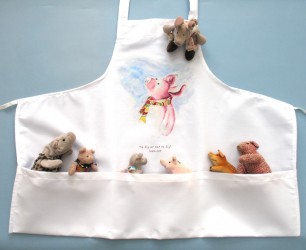 These shorter bib aprons (28''x23'') feature 3 large lower pockets, 100% spun polyester, machine wash. Choose one of the unique drawings: 'Little Rooster', 'Spring chick' and 'Ham-let' the little piglet.